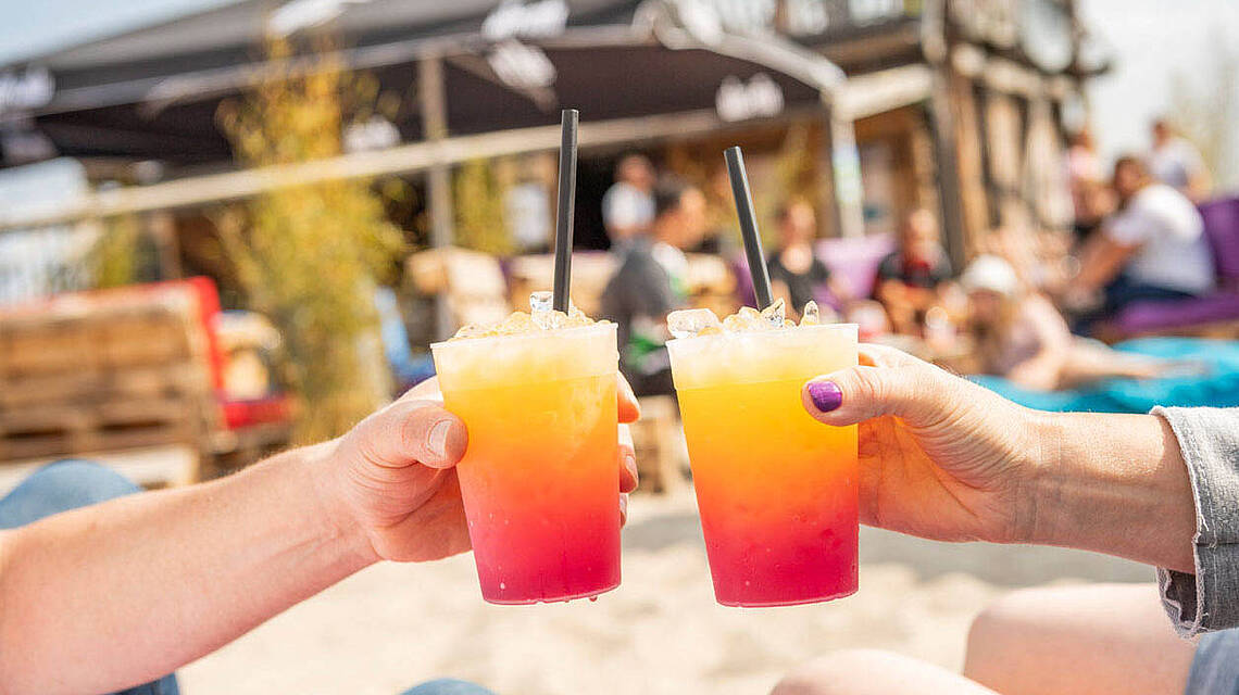Zwei Personen stoßen mit Ihren Cocktails an