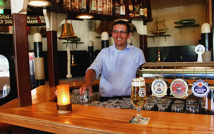 Moby Dick Ostsee Resort Dampland Barkeeper steht im Moby Dick hinter dem Tresen